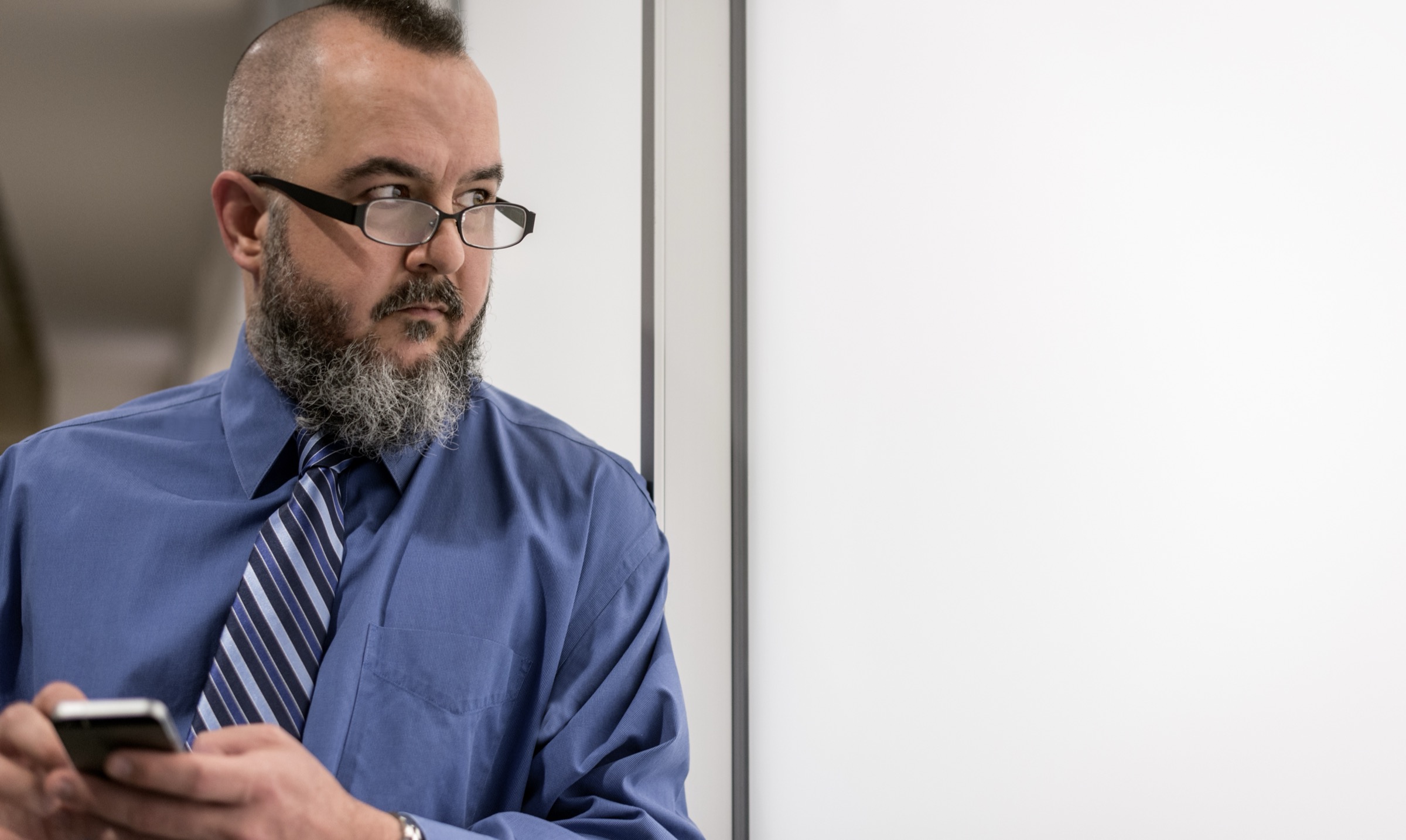 Jeff, a corporate and tech law attorney, reviewing a contract on his phone.
